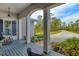 Inviting front porch view with rocking chairs, plants, and lush greenery at 19610 66Th E Ave, Bradenton, FL 34211