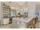 Spacious kitchen featuring stainless steel appliances, white cabinets, gray countertops, and open shelving at 19610 66Th E Ave, Bradenton, FL 34211