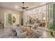 Inviting seating area with neutral decor, ceiling fan, and view of other rooms through the large sliding glass doors at 19610 66Th E Ave, Bradenton, FL 34211