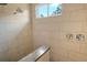 Shower stall features large format tile, bench, and sleek fixtures at 19610 66Th E Ave, Bradenton, FL 34211