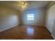 Bright bedroom featuring a large window, closet, and laminate flooring, offering a comfortable living space at 2001 Logsdon St, North Port, FL 34287