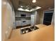 Functional kitchen with white appliances, a skylight, ample counter space, and a double sink overlooking the living area at 2001 Logsdon St, North Port, FL 34287