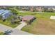 Aerial view featuring the home, in-ground pool, long driveway and nearby golf course at 2080 Padre Island Dr # 211, Punta Gorda, FL 33950