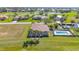 Aerial view of property showcasing an in-ground pool, lush landscaping and nearby golf course at 2080 Padre Island Dr # 211, Punta Gorda, FL 33950