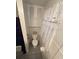 Narrow bathroom with a toilet, shower/tub with curtain and small cabinet at 2107 36Th E Ave, Palmetto, FL 34221