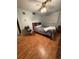 Well-lit bedroom includes a comfortable bed and wooden floors at 2107 36Th E Ave, Palmetto, FL 34221