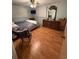 Cozy bedroom featuring hardwood floors, a ceiling fan and a large wooden dresser at 2107 36Th E Ave, Palmetto, FL 34221