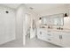 Elegant bathroom with dual sink vanity, white cabinets, black hardware, and tiled walk-in shower at 2202 Waldemere St, Sarasota, FL 34239