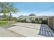 Long concrete driveway with decorative grass lines leads to a well-maintained, modern home exterior at 2202 Waldemere St, Sarasota, FL 34239