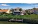 Waterfront home with a sunroom and backyard with mature landscaping at 27 Inlets Blvd # 27, Nokomis, FL 34275