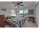 Bedroom with ceiling fan, large window with blinds, and neutral carpet at 27 Inlets Blvd # 27, Nokomis, FL 34275