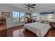 Bright bedroom with hardwood floors and a large window overlooking a green landscape at 27 Inlets Blvd # 27, Nokomis, FL 34275