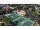 Aerial perspective of a community with tennis courts, providing an overview of the sports facilities available to residents at 27 Inlets Blvd # 27, Nokomis, FL 34275