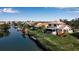 Aerial view of a waterfront property with lush landscaping and a private dock, perfect for boaters at 27 Inlets Blvd # 27, Nokomis, FL 34275