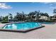 Outdoor pool with clear blue water, a hot tub, and lounge chairs under sunny skies at 27 Inlets Blvd # 27, Nokomis, FL 34275