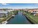 Aerial view of a waterfront community featuring lush landscaping and boat docks along a tranquil canal at 27 Inlets Blvd # 27, Nokomis, FL 34275