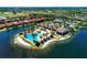 An aerial shot showing a resort-style pool and clubhouse overlooking a lake in a beautiful community at 272 Maraviya Blvd, Nokomis, FL 34275