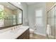 Stylish bathroom with a modern vanity, quartz countertop, and frameless glass shower at 272 Maraviya Blvd, Nokomis, FL 34275