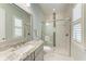 Bathroom showcasing a glass-enclosed shower, neutral walls, and a bright window at 272 Maraviya Blvd, Nokomis, FL 34275