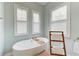 Bright and airy bathtub features shutters and a wooden towel rack at 272 Maraviya Blvd, Nokomis, FL 34275