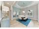 Dining room featuring a modern chandelier, large mirrors, and beautiful wood-look tile at 272 Maraviya Blvd, Nokomis, FL 34275