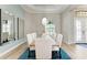 Elegant dining room featuring a modern chandelier, mirrors, and a table for eight at 272 Maraviya Blvd, Nokomis, FL 34275