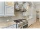 This modern kitchen features stainless steel appliances, mosaic backsplash and custom white cabinets at 272 Maraviya Blvd, Nokomis, FL 34275