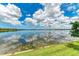 A bright blue sky reflects off the clear waters of the lake at 272 Maraviya Blvd, Nokomis, FL 34275