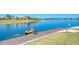 A person enjoying kayaking on a lake with a wooden dock for launching, showcasing the community's waterfront lifestyle at 272 Maraviya Blvd, Nokomis, FL 34275