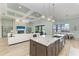 The large kitchen island views into the large living space with fireplace and dining room at 272 Maraviya Blvd, Nokomis, FL 34275