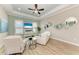 Bright living room with tray ceiling, ceiling fan, and comfortable seating arrangement at 272 Maraviya Blvd, Nokomis, FL 34275