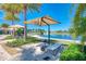 Serene lakeside lounge area with comfortable seating and shade, perfect for relaxation by the water at 272 Maraviya Blvd, Nokomis, FL 34275