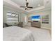 Spacious main bedroom with a tray ceiling, water view, and decorative paintings at 272 Maraviya Blvd, Nokomis, FL 34275