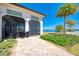 Screened in patio with travertine tile floors, providing a comfortable outdoor living space with scenic lake views at 272 Maraviya Blvd, Nokomis, FL 34275