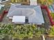 An aerial view of a single-story house with a gray roof, surrounded by lush greenery and a well-maintained fence at 2746 Tangelo Dr, Sarasota, FL 34239