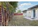 Exterior view of the backyard, showcasing the red wooden fence and a small patio at 2746 Tangelo Dr, Sarasota, FL 34239