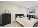 Cozy bedroom showcasing hardwood floors, a comfortable bed, and a view from the window at 2746 Tangelo Dr, Sarasota, FL 34239