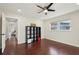 Bedroom featuring hardwood floors, ceiling fan and a large window at 2746 Tangelo Dr, Sarasota, FL 34239