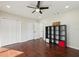 Bedroom with ceiling fan, closet, and dark hardwood floors at 2746 Tangelo Dr, Sarasota, FL 34239