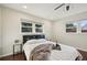 Serene bedroom with a cozy bed, ceiling fan, and natural light from two windows at 2746 Tangelo Dr, Sarasota, FL 34239