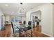 Open concept dining area featuring a modern light, glass table, and easy access to the living room and kitchen at 2746 Tangelo Dr, Sarasota, FL 34239