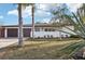 Lovely home showcasing its exterior with a two-car garage and well-maintained landscaping at 2746 Tangelo Dr, Sarasota, FL 34239