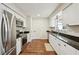 Modern kitchen featuring stainless steel appliances, granite countertops, and white cabinets at 2746 Tangelo Dr, Sarasota, FL 34239