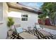 Outdoor patio area furnished with two lounge chairs, a patterned rug, and a small table at 2746 Tangelo Dr, Sarasota, FL 34239