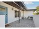 Covered front porch with tiled flooring, stylish seating, and a welcoming entrance to the home at 2746 Tangelo Dr, Sarasota, FL 34239