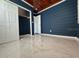 Bedroom with marble floors features blue walls and wood paneled ceiling at 2785 Sydelle St, Sarasota, FL 34237