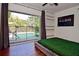 Bedroom with pool view, hardwood floors, ceiling fan and a gray platform bed at 2785 Sydelle St, Sarasota, FL 34237