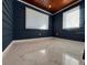 Bedroom with marble floors features blue walls and wood paneled ceiling with natural light from two windows at 2785 Sydelle St, Sarasota, FL 34237