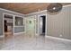 Elegant dining area featuring wood paneling, a modern light fixture, and marble floors at 2785 Sydelle St, Sarasota, FL 34237