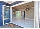 Elegant dining area featuring wood paneling, a modern light fixture, and marble floors at 2785 Sydelle St, Sarasota, FL 34237